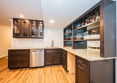 Basement bar renovation in Oakton, VA featuring dark custom cabinets